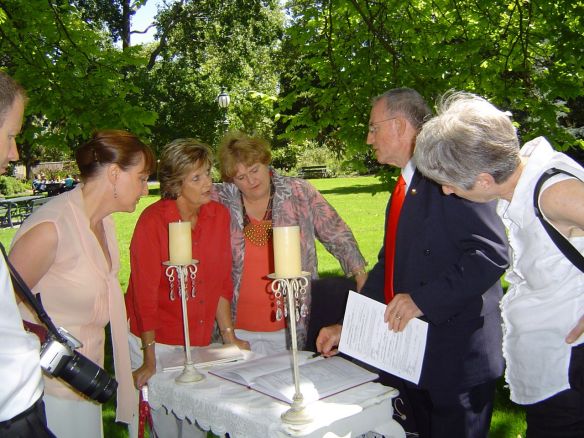 Celebrant, having just completed a marriage ceremony, explains procedures to student and new celebrants.
